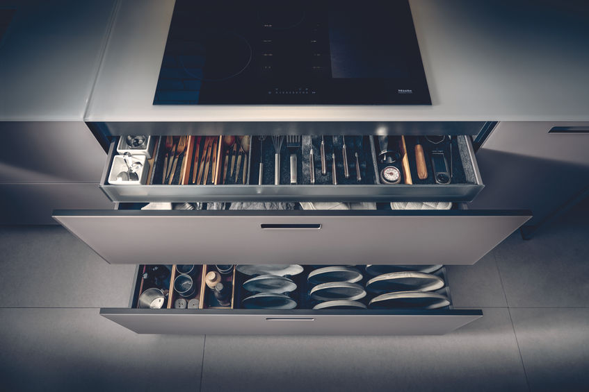 Open view of Next125 high-end German kitchen's drawer pack revealing an integrated cutlery drawer.