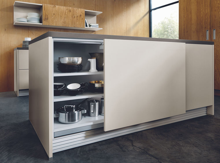 Next125 high-end German kitchen featuring a sliding cabinet front for innovative storage solutions.