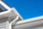 Colonial white gutter guard system, soffit providing ventilation to the attic, with gray