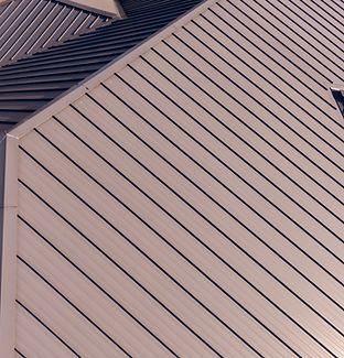 Sunny Daytime Drone Images Of a Brown Standing Seam Metal Roof On A Commercial Building_ N