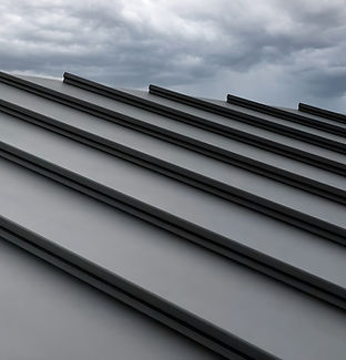 Close-up house retro roof panel with standing seam and fasteners. Classic style black meta