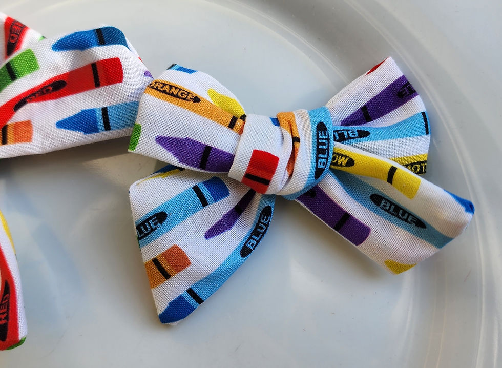 Handmade crayon print hair bows in bright colors.