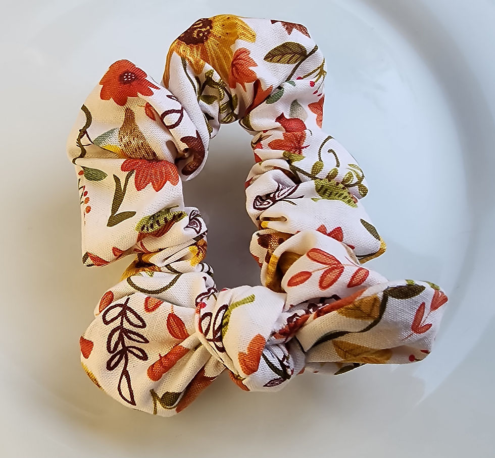 Fall floral bow scrunchie with autumn-colored flowers on cream fabric.