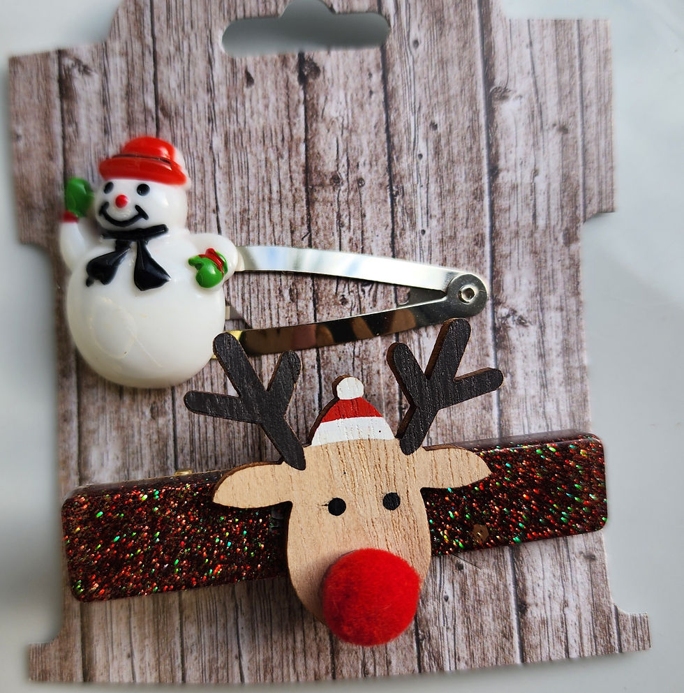 Thumbnail: Retro-style Christmas hair clips with a glittery reindeer face and a cheerful snowman wearing a red hat, displayed on a rusti
