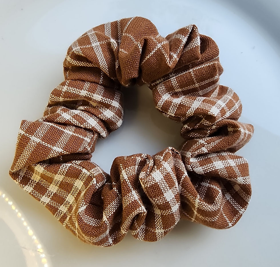 Brown and cream plaid fabric scrunchie hair tie.