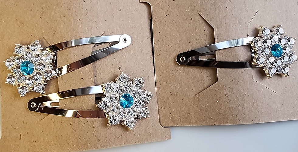 Two brown display cards with handmade blue rhinestone snowflake hair clips, one showing a set of two clips and one showing a