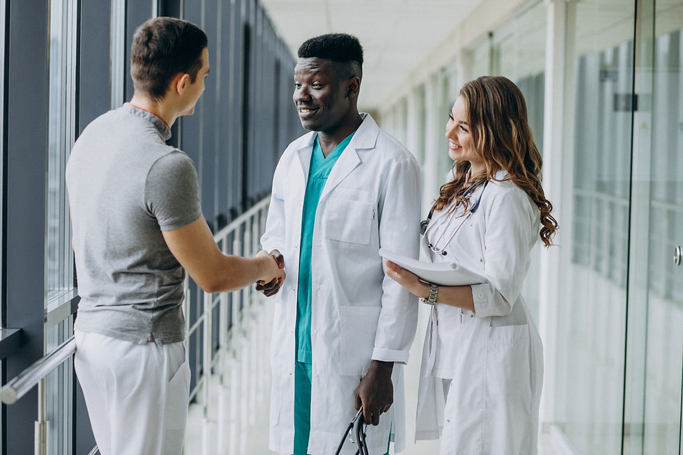 doctors-shaking-hands-with-patient-standing-corridor-hospital.jpg