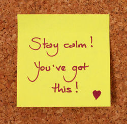 Yellow Post-It Note on a Cork Board Back