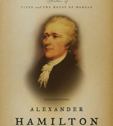 Eye-level view of a worn leather-bound book titled "Alexander Hamilton" resting on a wooden table