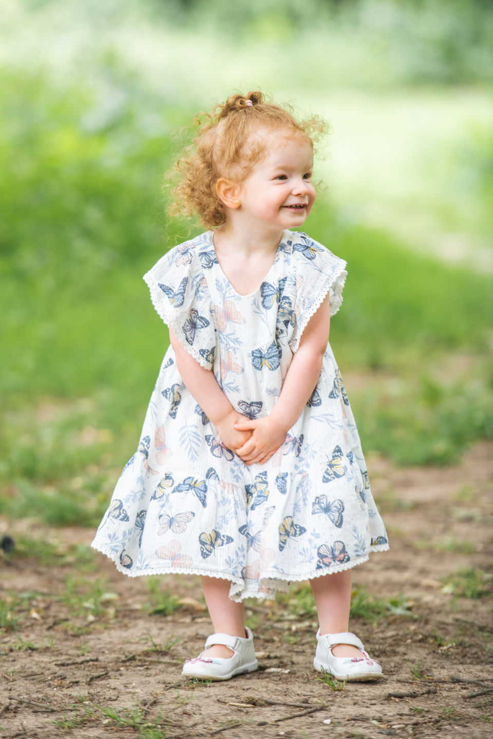 Little girl smiling outdoors during a Kent family photoshoot