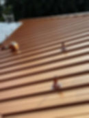 Dark bronze standing seam metal roof installation by Advanced Roof Tech