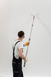 medium-shot-young-man-painting-wall.jpg
