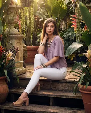 Model sitting on steps in an outdoor setting