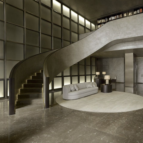 Sleek modern interior with a curved staircase, minimalist furniture, and sophisticated lighting, designed by Leli Construction in Los Angeles.