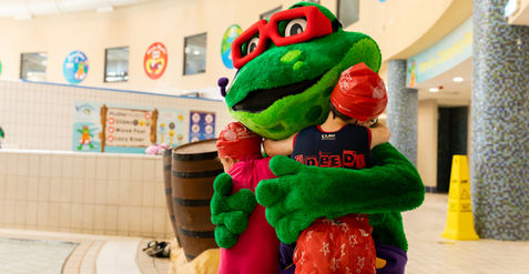 finnie the frog hugging kids at the aquazone