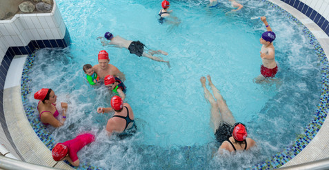 people in the piranha pool in the lazy river
