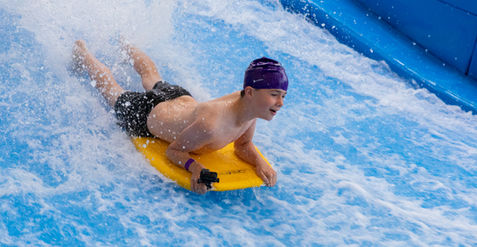 child on the slide at aquazone