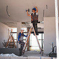 full-shot-man-woman-standing-ladder.jpg