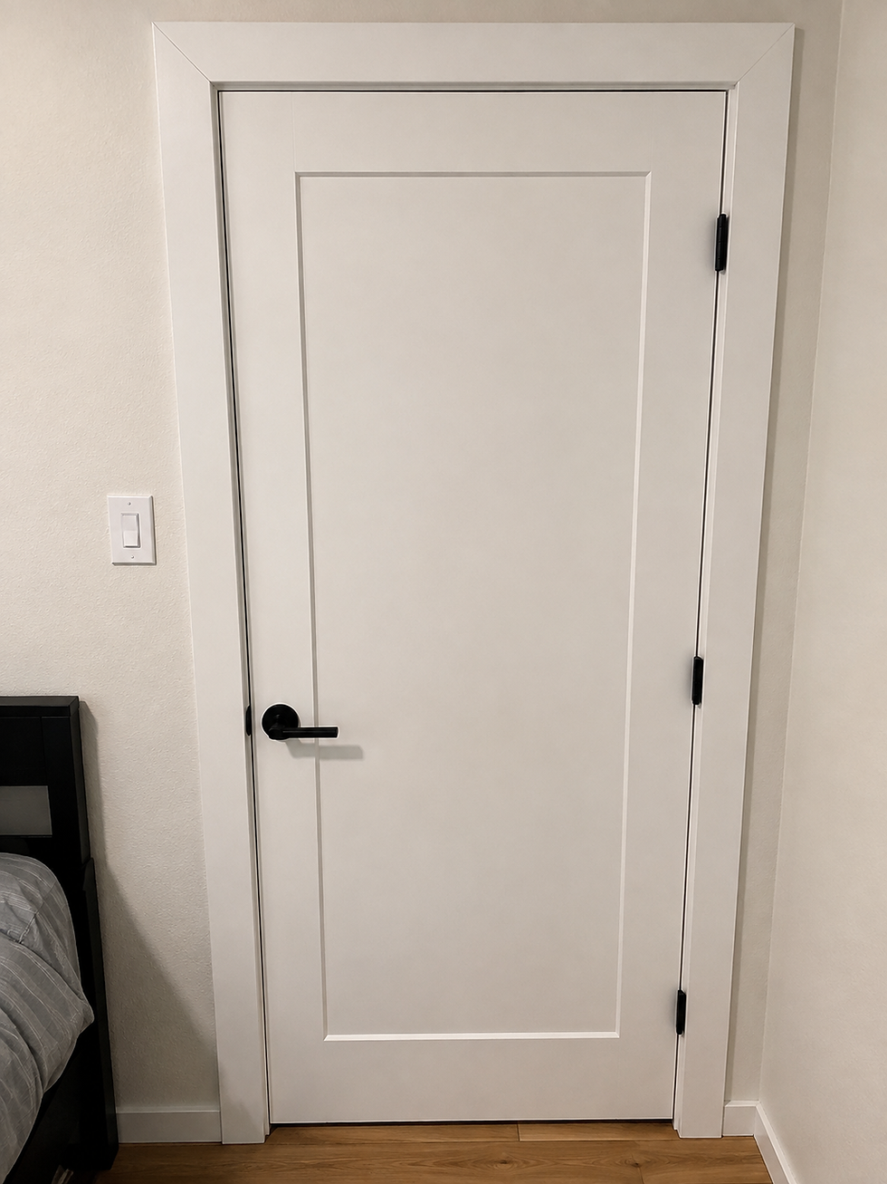 White interior door installation with black lever hardware