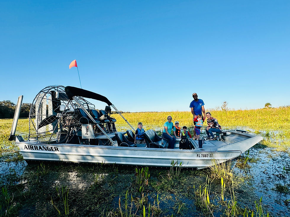 Airboat on the lake with blue sky and green grass