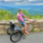 Man with adaptive wheelchair on a scenic mountain overlook