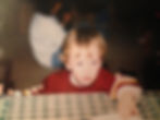 Young child with light hair at a table