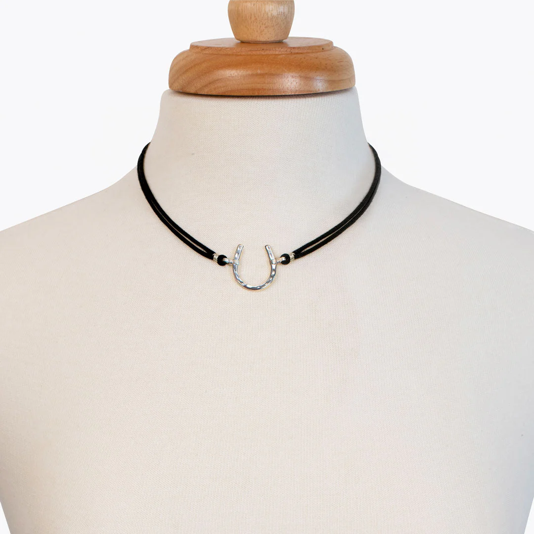a braided cord necklace with a silver horseshow in the center chosen by a GA equine photographer