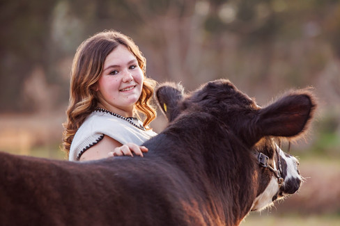 FFA livestock photography as a senior student poses with her cattle