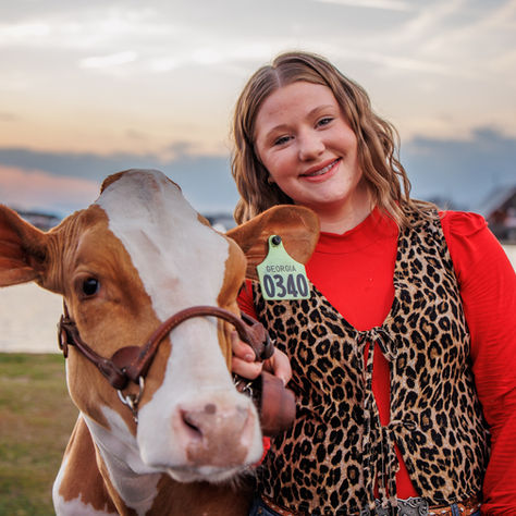 A high school FFA member poses with her Holstein for a cow portrait session at the Georgia National Fairgrounds and Agri-center in Perry, GA