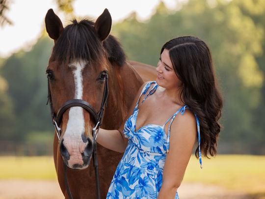 a girl with her bay warmblood for a horse and rider portrait by a GA senior photographer