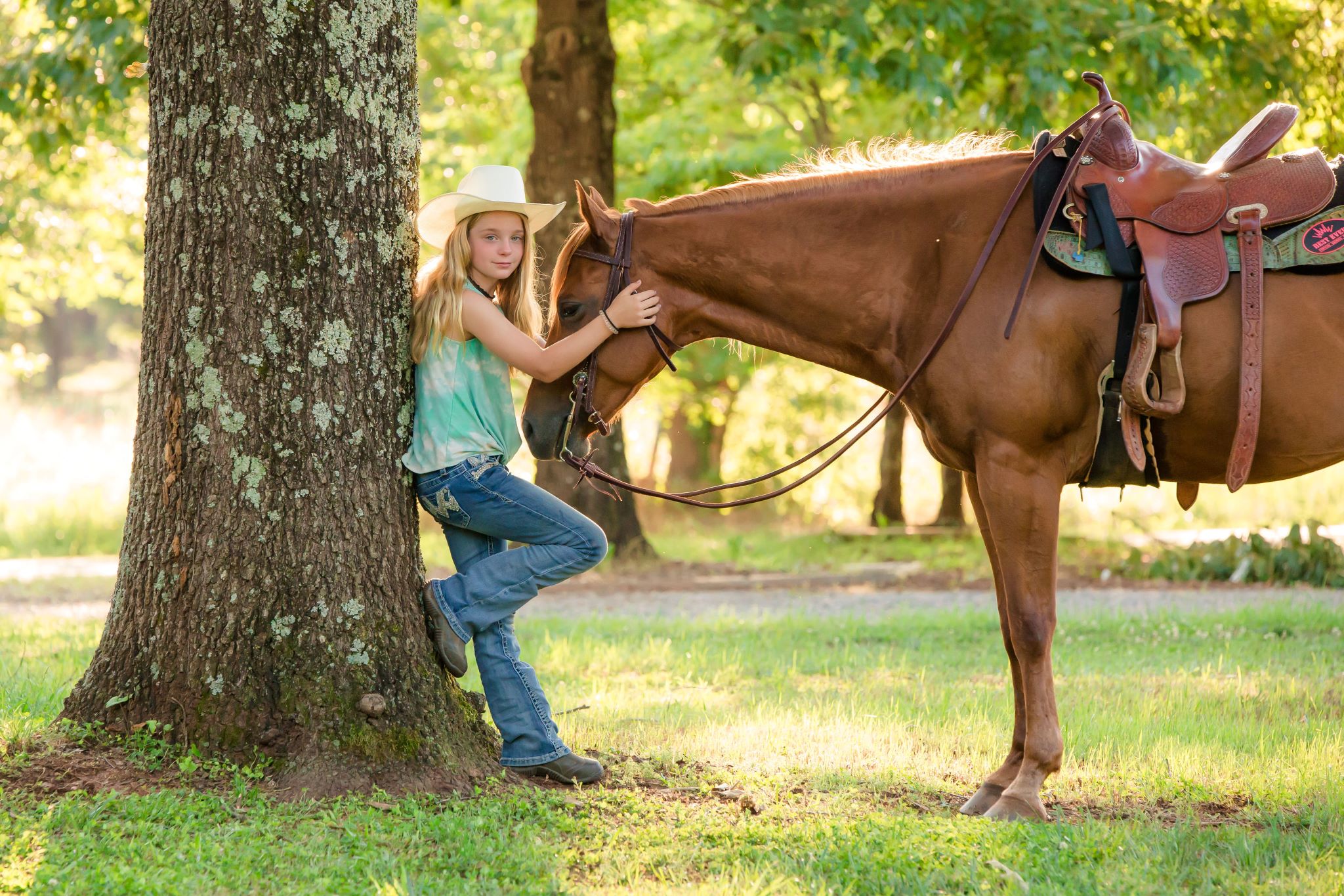 Girl leaning against a tree, hugging horse. Horse and Rider Portrait by K. Williams Photography in Georgia.