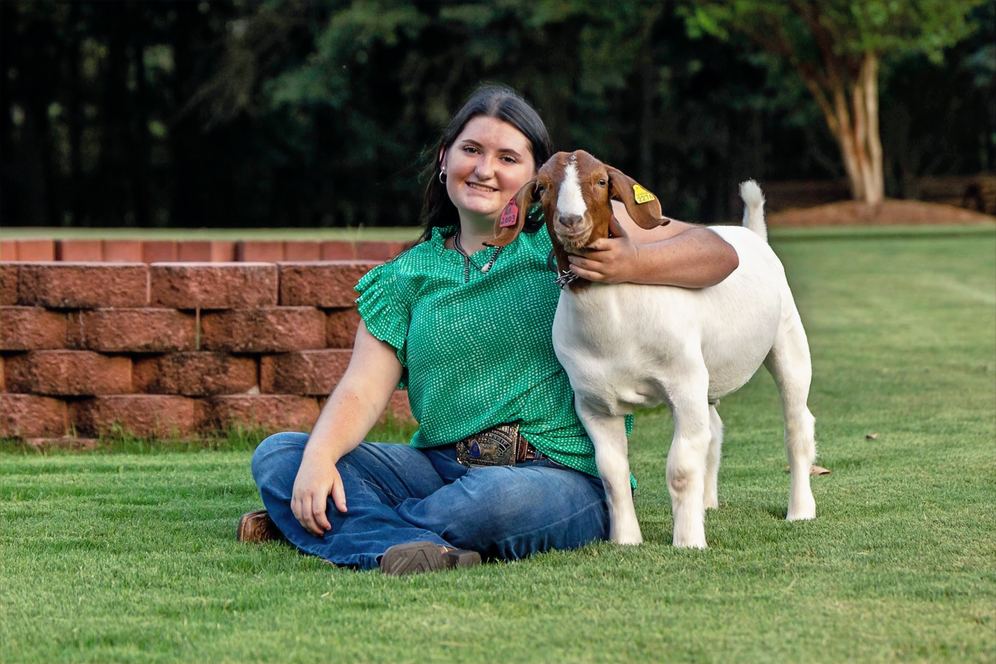 GA senior girl poses with goat in a livestock portrait