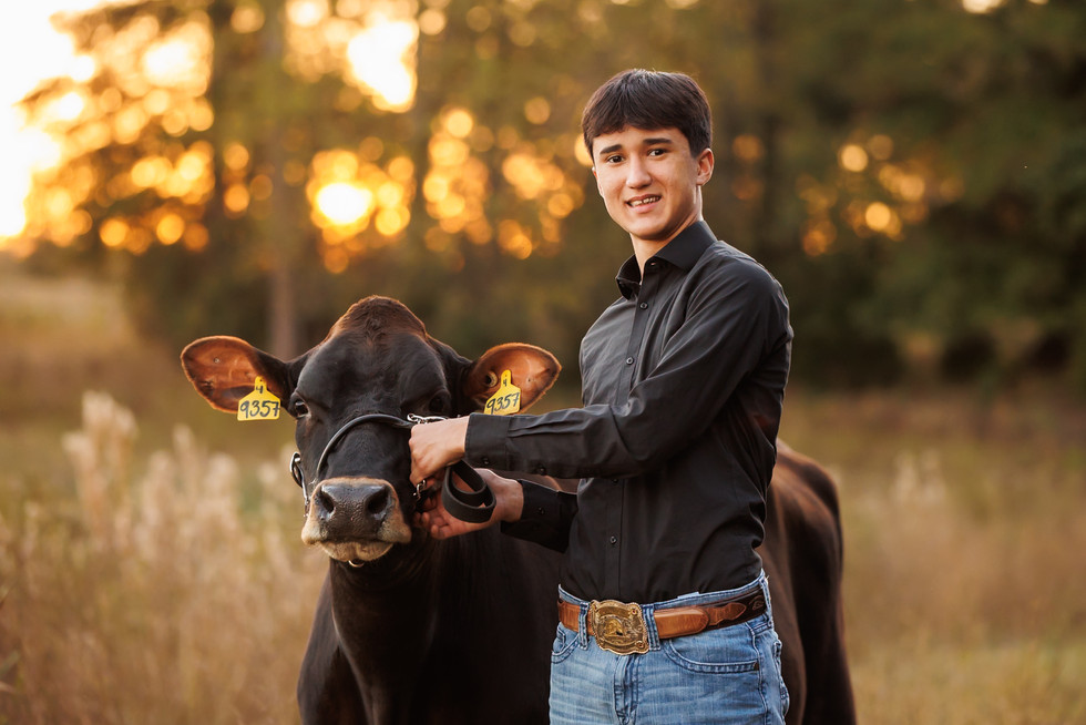 GA FFA student poses with project animal for a Jersey cow photography session