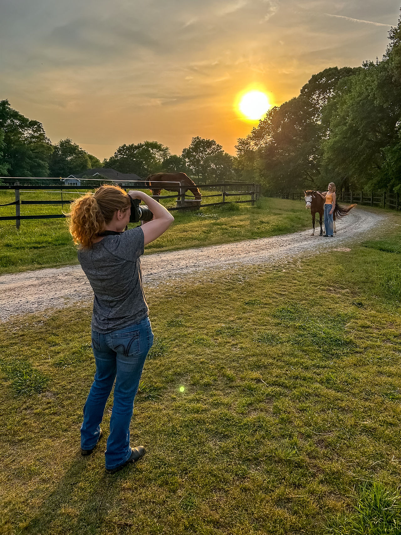 A high school senior girl poses with her paint horse in an equestrian senior portrait outside of Athens, GA