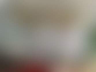 A decorated Eid display featuring gold and white balloons, patterned rugs, lanterns and traditional serving trays.