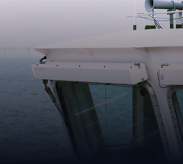 Vessel pilothouse windows and radar mast in foggy conditions, dark editorial overlay