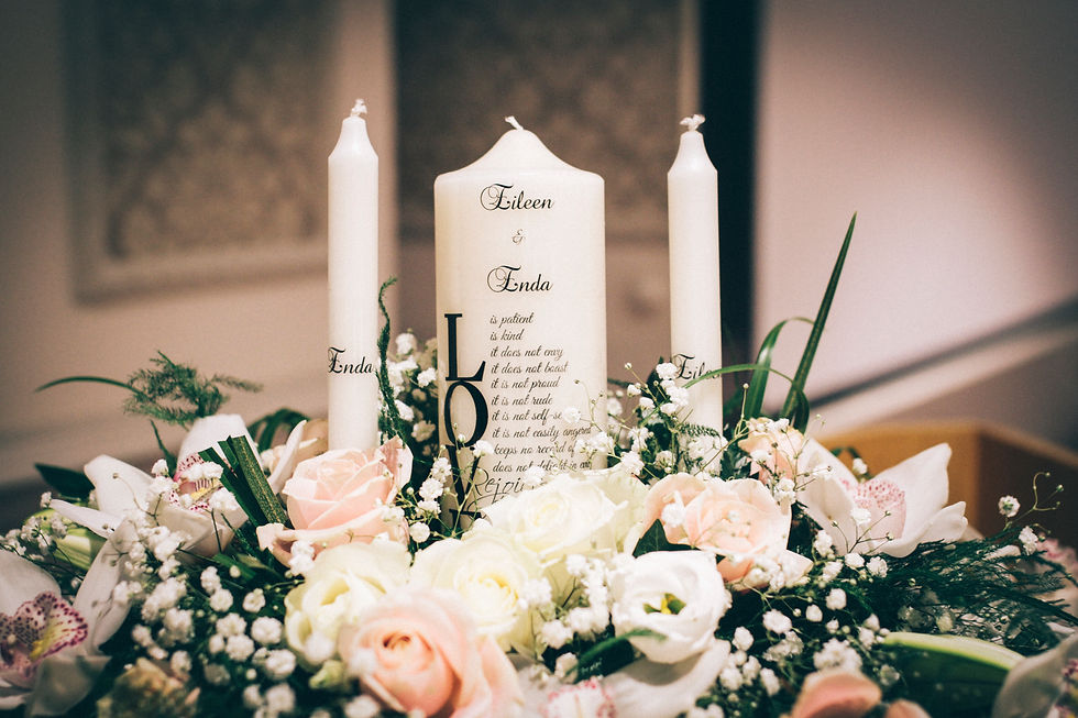 Trinity Candles in Flower Arrangment