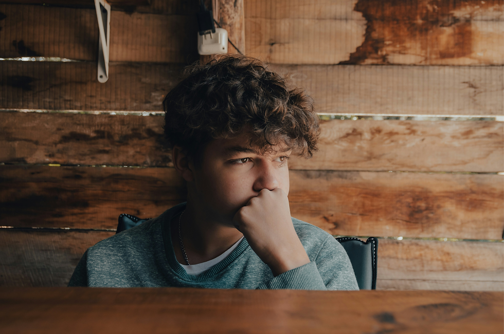 Anxious teen with hand on chin