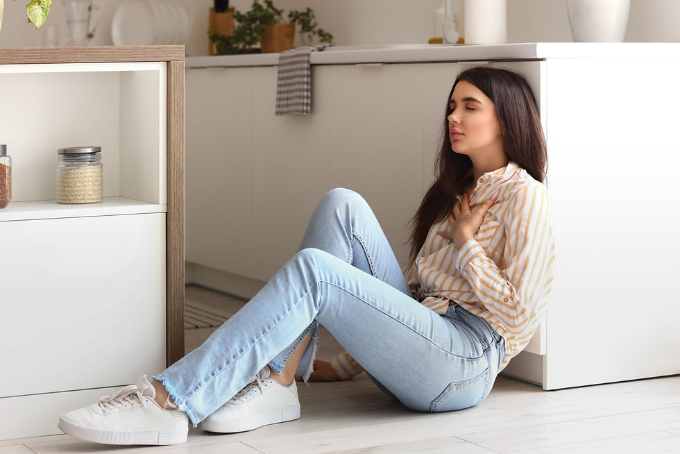 woman sitting on floor experiencing anxiety