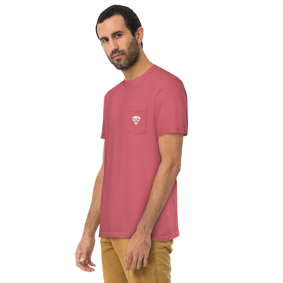 Front-side view of a male model in a watermelon-colored, pocket tee, showing off a white pocket design that includes a diamond encapsulating a depth-provoking sunset happening between palm trees and behind ocean.