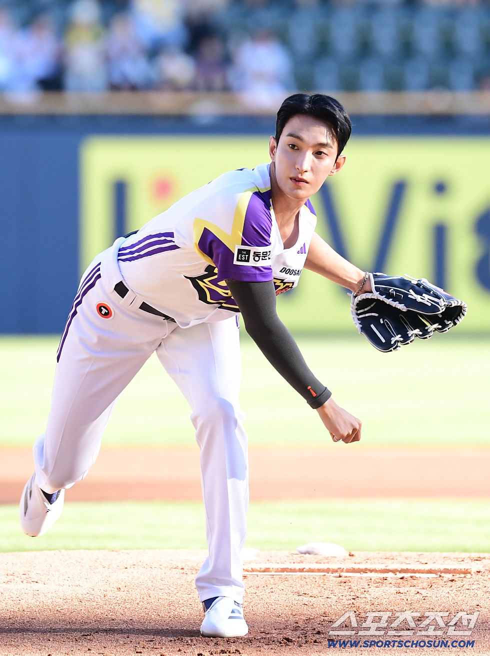 Dokyeom throwing a powerful first pitch on the mound.
