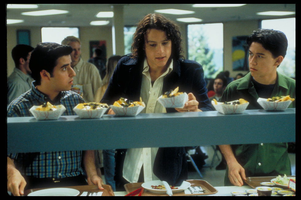 In line at a high school cafeteria, Heath Ledger as Patrick Verona grabs some food, doing his best to ignore the geeky Michael, played by David Krumholtz, in line beside him.
