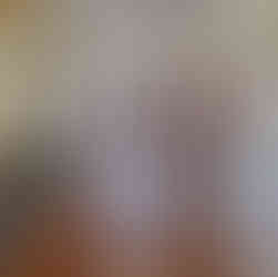 View down a long hallway, mural along the right wall shows four hands of various skin tones holding native flowers