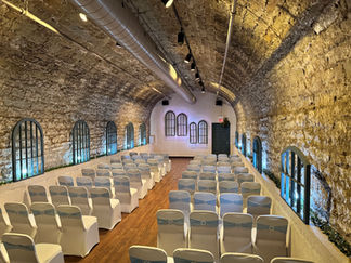 Arched stone wedding ceremony room with white chairs, Banquet Venue in Columbus Ohio.