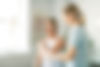 A Modern rehabilitation physiotherapy worker with woman client.jpg