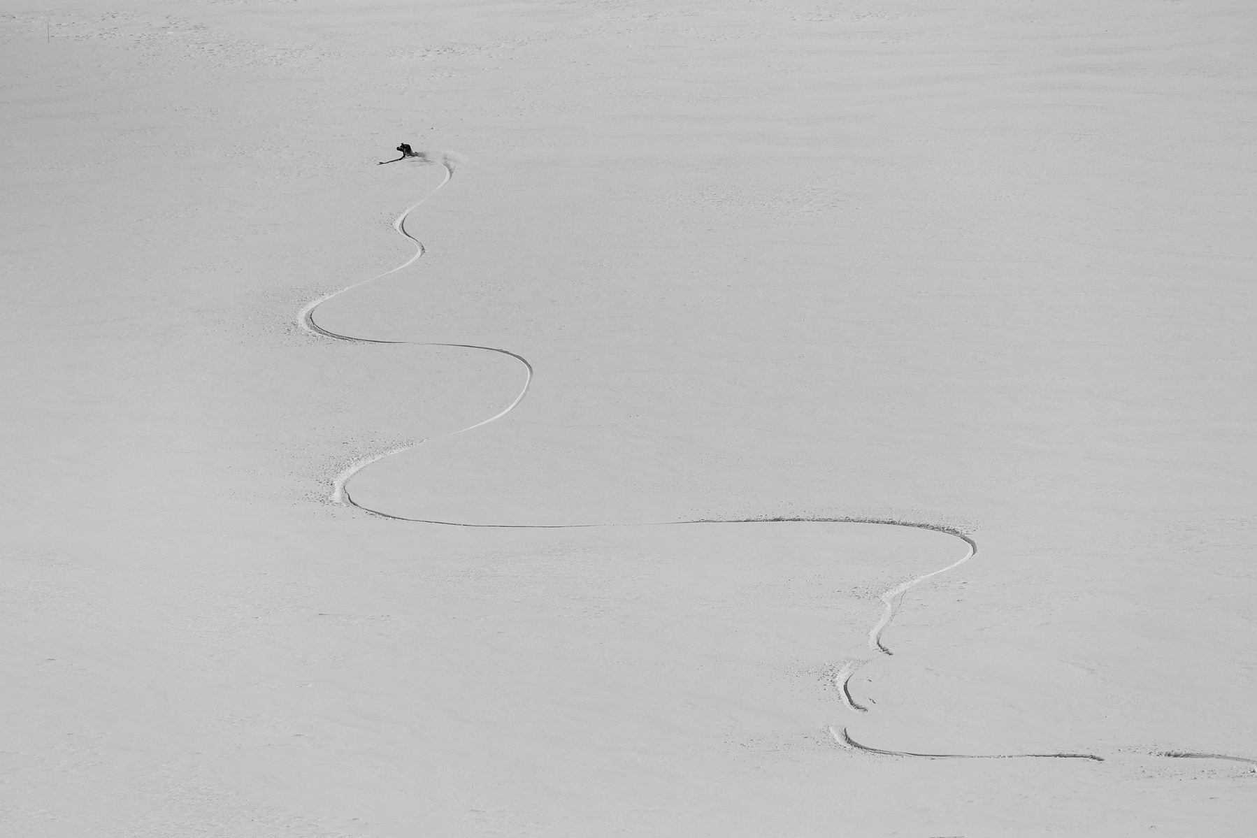 Ski track across a wide expanse of snow