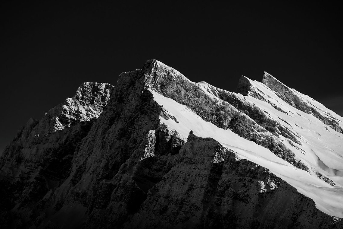 Snow-covered mountain ridge in black and white