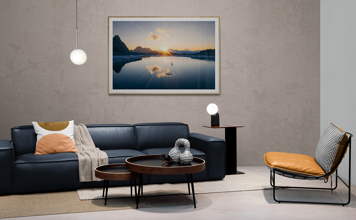 Fine-art work above a leather sofa