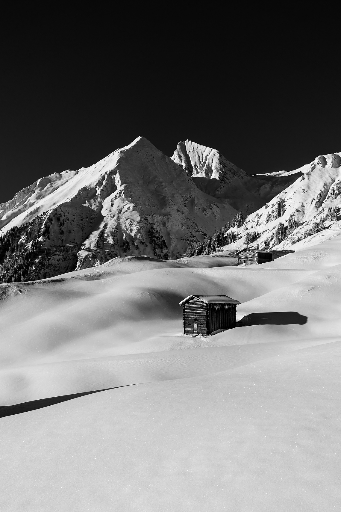 Silent Hut: wooden hut in a snow-covered mountain landscape