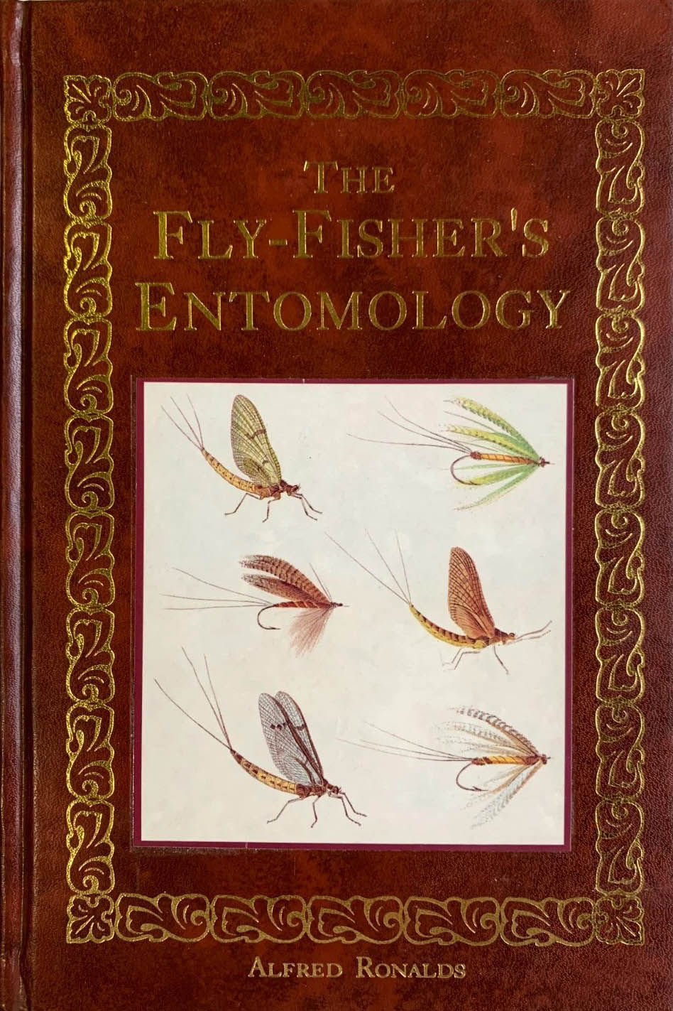 Book cover of The Fly Fishers Entomology by Alfred Ronalds 1836 leather bound edition, the foundational fly fishing entomology classic featuring hand-colored illustrations of natural insects and matching artificial trout flies
